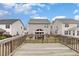 Exterior view from wooden deck of backyard and neighboring two-story homes with vinyl siding at 2013 Magnolia Tree Ln, Durham, NC 27703