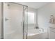 Stylish bathroom with a glass-enclosed shower and separate soaking tub at 2013 Magnolia Tree Ln, Durham, NC 27703