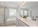 Bright bathroom featuring double sinks, granite counters, and a tub-shower combo at 2013 Magnolia Tree Ln, Durham, NC 27703
