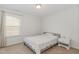 Cozy bedroom featuring a double bed, carpeted floor, and a window at 2013 Magnolia Tree Ln, Durham, NC 27703