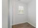 Small bedroom featuring light wood flooring, large closet, and window at 2013 Magnolia Tree Ln, Durham, NC 27703