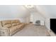 Finished bonus room with neutral carpet, loveseat, chair, and white trim at 2013 Magnolia Tree Ln, Durham, NC 27703