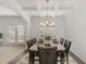 Inviting dining room featuring a coffered ceiling, a chandelier, and a view of the outdoor space at 2013 Magnolia Tree Ln, Durham, NC 27703
