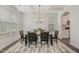 Elegant dining room with a coffered ceiling, stylish chandelier, and a view of the modern kitchen at 2013 Magnolia Tree Ln, Durham, NC 27703