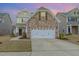Inviting two-story home featuring a stone facade and attached two-car garage, nestled in a well-maintained community at 2013 Magnolia Tree Ln, Durham, NC 27703