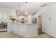 Modern kitchen with white cabinetry, stainless steel appliances, and a breakfast bar overlooking the living area at 2013 Magnolia Tree Ln, Durham, NC 27703