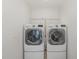 Bright laundry room with modern LG washer and dryer units and white wire rack at 2013 Magnolia Tree Ln, Durham, NC 27703