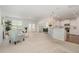 Open-concept living space with a fireplace, seamlessly connected to the dining area and a modern kitchen at 2013 Magnolia Tree Ln, Durham, NC 27703
