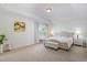 Light-filled main bedroom featuring tray ceilings, a queen bed, and an ensuite bathroom at 2013 Magnolia Tree Ln, Durham, NC 27703