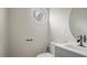 Clean half bathroom with modern sink, updated fixtures, and a unique window feature at 206 Rocky Hills Rd, Pittsboro, NC 27312