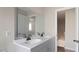 Bathroom features double sinks with modern faucets and a large mirror over wood-style flooring at 206 Rocky Hills Rd, Pittsboro, NC 27312