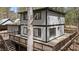 Exterior shot of the home with the spacious deck and wooded surrounding area at 206 Rocky Hills Rd, Pittsboro, NC 27312