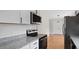 The kitchen is equipped with stainless steel appliances and a white backsplash, leading to wood flooring at 206 Rocky Hills Rd, Pittsboro, NC 27312