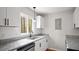 Bright kitchen features granite countertops, stainless steel dishwasher, subway tile backsplash, and natural light at 206 Rocky Hills Rd, Pittsboro, NC 27312