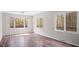 Bright living room featuring wood floors, large windows, and serene natural views at 206 Rocky Hills Rd, Pittsboro, NC 27312