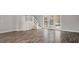 Spacious living room features wood-style flooring, French doors, and stairs to another level at 206 Rocky Hills Rd, Pittsboro, NC 27312