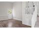 Bright living room features wood-style flooring, stairs to another level, and natural light at 206 Rocky Hills Rd, Pittsboro, NC 27312