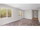 Bright living room featuring wood floors, large windows, and access to the outside at 206 Rocky Hills Rd, Pittsboro, NC 27312