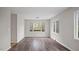 Bright living room featuring wood floors, large windows, and neutral paint at 206 Rocky Hills Rd, Pittsboro, NC 27312