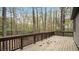 Inviting wooden deck with dark railing, offering a relaxing outdoor space amidst the trees at 206 Rocky Hills Rd, Pittsboro, NC 27312