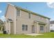 Two-story house exterior with a well-maintained lawn and a cozy patio area in the backyard at 2223 Lazy River Dr, Raleigh, NC 27610