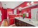 Red primary bathroom featuring a large double vanity with white countertops and tile floors at 2223 Lazy River Dr, Raleigh, NC 27610