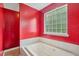 Luxurious primary bathroom with a soaking tub and a privacy window at 2223 Lazy River Dr, Raleigh, NC 27610
