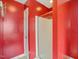 This bathroom features bright red walls, a glass enclosed shower, and modern fixtures at 2223 Lazy River Dr, Raleigh, NC 27610