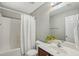 Neutral bathroom with a white shower curtain, toilet, dark vanity and mirror at 2223 Lazy River Dr, Raleigh, NC 27610