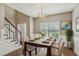 Formal dining area featuring a glass top table set for six and staircase detail at 2223 Lazy River Dr, Raleigh, NC 27610
