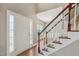 Bright foyer with hardwood floors, staircase, and welcoming natural light from the front door at 2223 Lazy River Dr, Raleigh, NC 27610