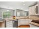 Well-lit kitchen featuring stainless steel appliances and a view into the living area at 2223 Lazy River Dr, Raleigh, NC 27610