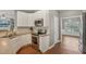 Bright kitchen with white cabinets, stainless steel appliances, and a subway tile backsplash at 2223 Lazy River Dr, Raleigh, NC 27610