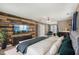 Beautiful living room with wood accent wall, TV, modern furniture, and a large comfortable bed at 2223 Lazy River Dr, Raleigh, NC 27610