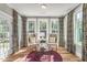 Cozy sitting area featuring wingback chairs, decorative curtains, and a stylish center table at 229 Savannah Moss Way # 121, Raleigh, NC 27603
