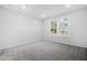Neutral bedroom illuminated by recessed lighting, carpet and a window at 2304 Beeblossom Pl, Fuquay Varina, NC 27526