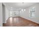Bright dining area with hardwood floors, chandelier, and multiple windows letting in natural light at 2304 Beeblossom Pl, Fuquay Varina, NC 27526