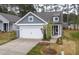 Charming home showcasing a gray exterior, white trim, and a two-car garage at 2304 Beeblossom Pl, Fuquay Varina, NC 27526