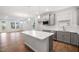 Modern kitchen featuring gray cabinets, stainless steel appliances, island and white countertops at 2304 Beeblossom Pl, Fuquay Varina, NC 27526