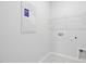 Laundry room with white walls, tile floors, and upper shelf storage at 2304 Beeblossom Pl, Fuquay Varina, NC 27526