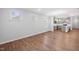 Bright open-concept living space with hardwood floors and multiple windows letting in natural light at 2304 Beeblossom Pl, Fuquay Varina, NC 27526