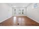 Bright open-concept living space with hardwood floors and multiple windows letting in natural light at 2304 Beeblossom Pl, Fuquay Varina, NC 27526