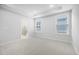 Bright bedroom featuring neutral carpet, recessed lighting, and two large windows that offer plenty of natural light at 2316 Beeblossom Pl, Fuquay Varina, NC 27526