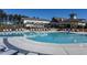 Community pool and clubhouse surrounded by lounge chairs and manicured grounds offer residents a luxurious outdoor space at 2316 Beeblossom Pl, Fuquay Varina, NC 27526