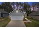 Attractive home showcasing a two-car garage, neat landscaping, and classic architectural details, radiating suburban charm at 2316 Beeblossom Pl, Fuquay Varina, NC 27526