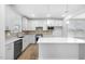 Kitchen with white cabinets, stainless appliances, tiled backsplash, and a large center island at 2316 Beeblossom Pl, Fuquay Varina, NC 27526