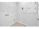 Functional laundry room featuring essential hookups and shelving, providing convenience and organization at 2316 Beeblossom Pl, Fuquay Varina, NC 27526