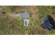 Aerial view showcases home, pool, and pond nestled among trees, highlighting privacy at 2411 Lynch Store Rd, Mebane, NC 27302