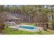 Backyard view of a brick home with pool, diving board, and a spacious backyard at 2411 Lynch Store Rd, Mebane, NC 27302