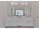Bright bathroom featuring a double vanity with a large mirror, tile flooring and ample storage space at 2411 Lynch Store Rd, Mebane, NC 27302